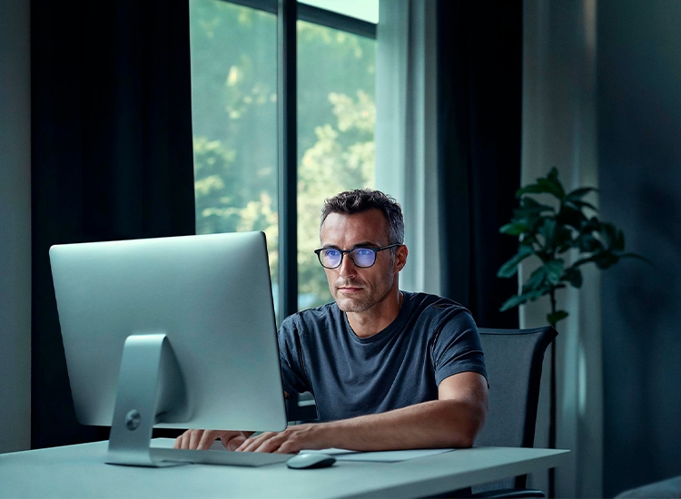 Man at a desktop computer reading news